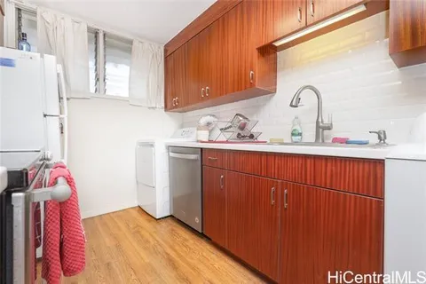 a kitchen with a sink cabinets and window