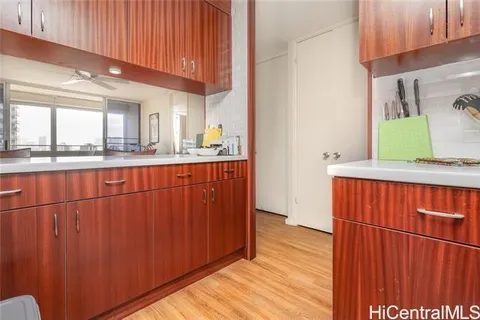 a kitchen with stainless steel appliances wooden cabinets and a counter top space