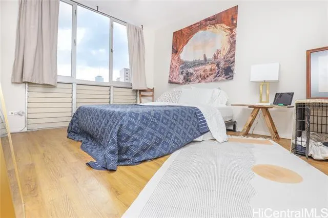 a living room with a bed and next to a window