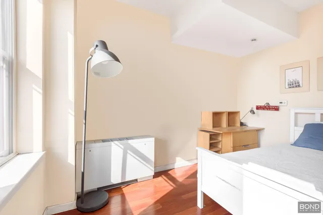 a view of kitchen and hall with wooden floor