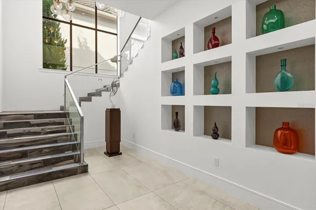 a bedroom with bed and large windows