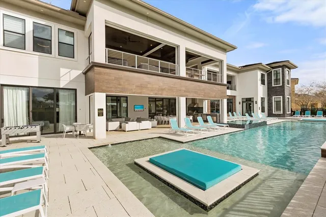 a bedroom with a large bed couch and a large window