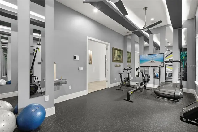 a bed room with gym equipment and a large window