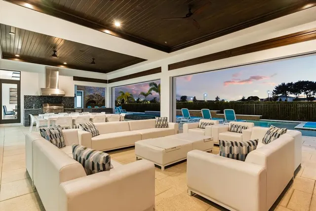 a living room with furniture a fireplace and kitchen view