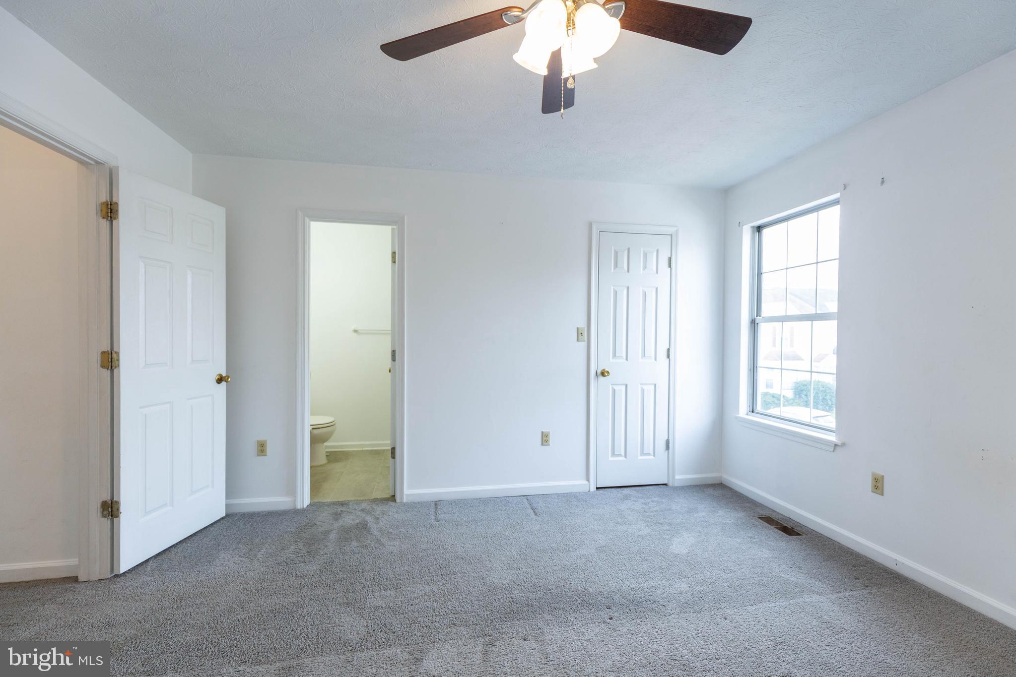 160 Stadium Circle Inwood, WV 25428 - Photo 25 of 29 an empty room with chandelier fan and windows