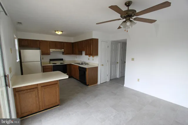 a kitchen with stainless steel appliances a refrigerator sink and cabinets