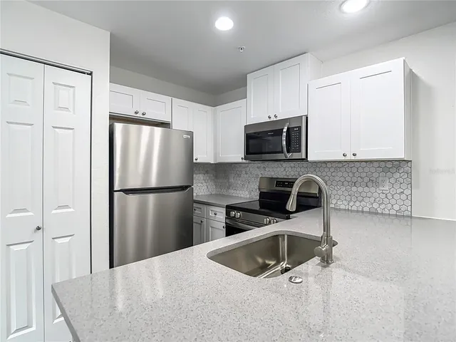 an aerial view of residential houses with yard