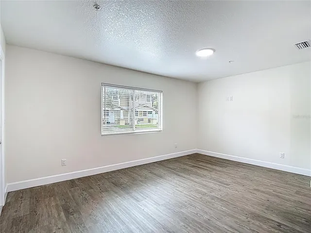 an aerial view of residential houses with outdoor space and parking