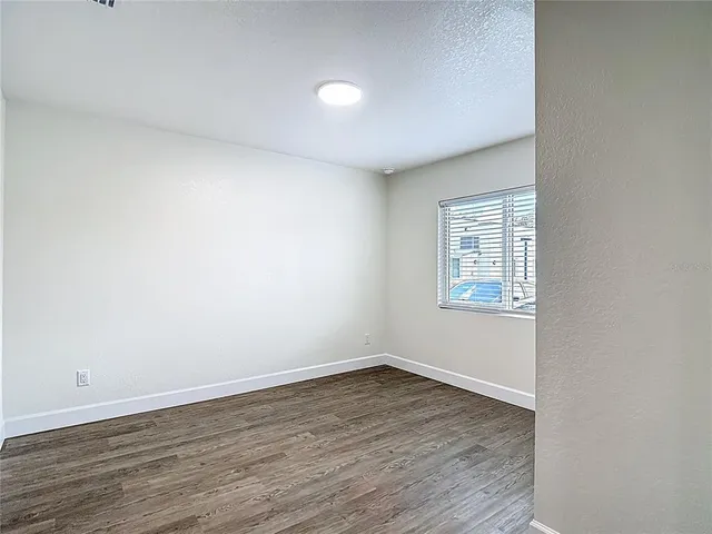a kitchen with granite countertop white cabinets and stainless steel appliances