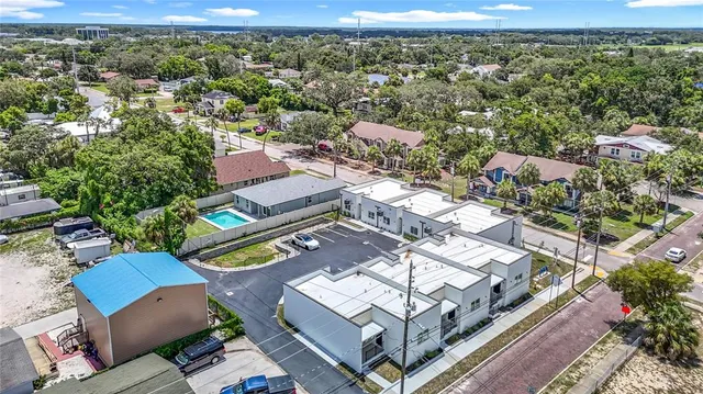 an empty room with wooden floor & closet area
