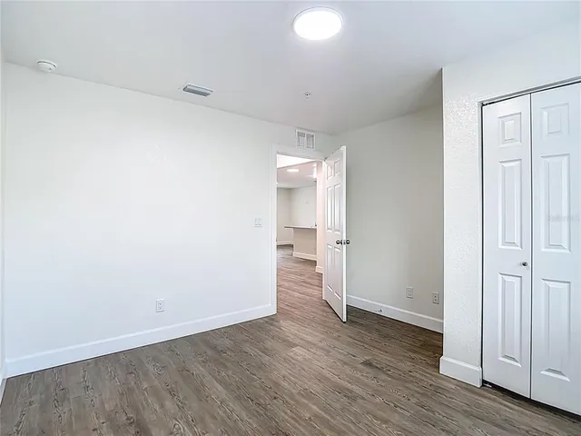 a view of a patio with table and chairs with wooden floor and fence