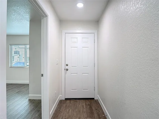 a kitchen with stainless steel appliances a refrigerator sink and white cabinets