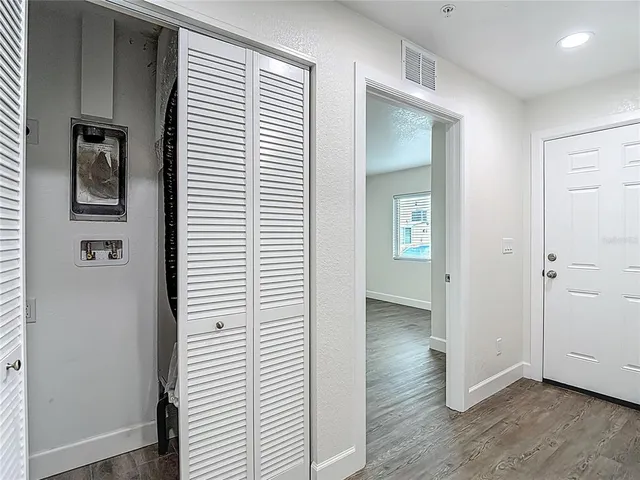 a large kitchen with stainless steel appliances kitchen island a large counter top and a stove top oven