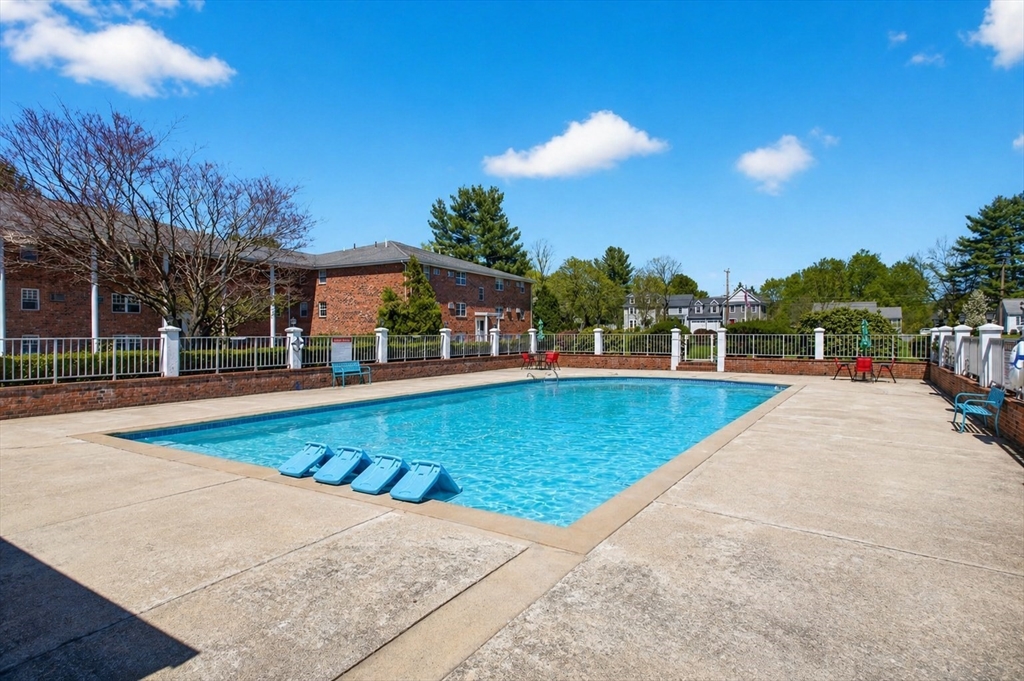 91 Pleasant Street, Unit A6 Medfield, MA 02052 - Photo 13 of 17 a view of a swimming pool with a patio