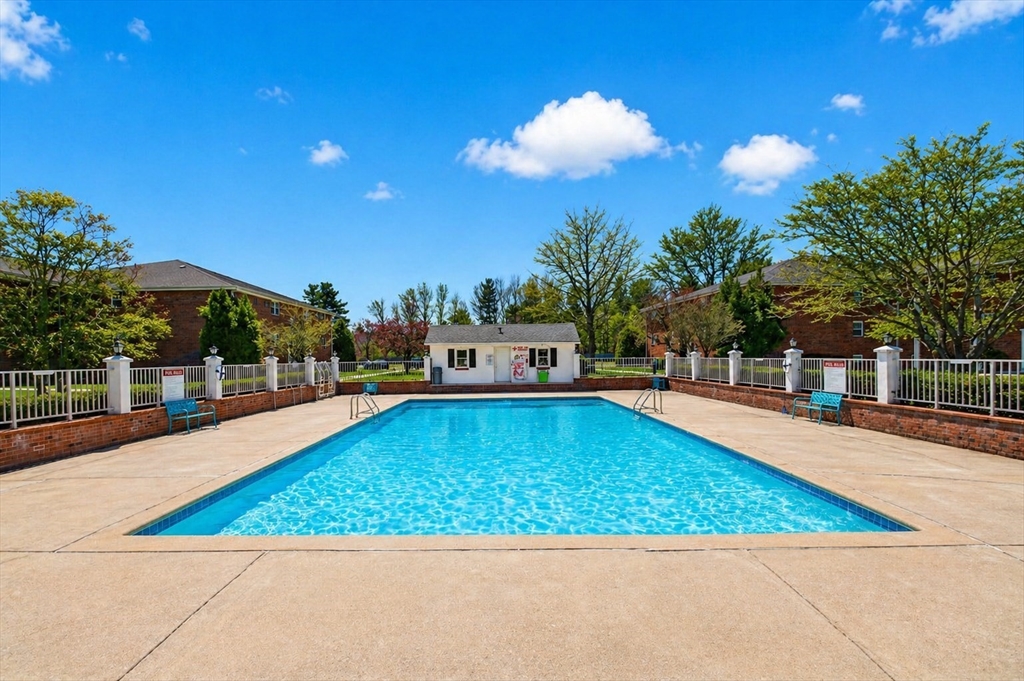 91 Pleasant Street, Unit A6 Medfield, MA 02052 - Photo 14 of 17 a view of a swimming pool with an outdoor space and seating area