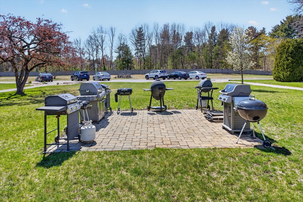91 Pleasant Street, Unit A6 Medfield, MA 02052 - Photo 15 of 17 a view of a table and chairs in the garden