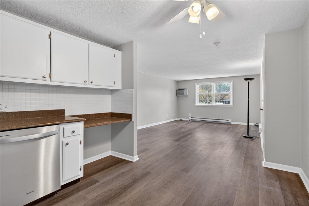91 Pleasant Street, Unit A6 Medfield, MA 02052 - Photo 4 of 17 a view of an empty room with wooden floor and a window