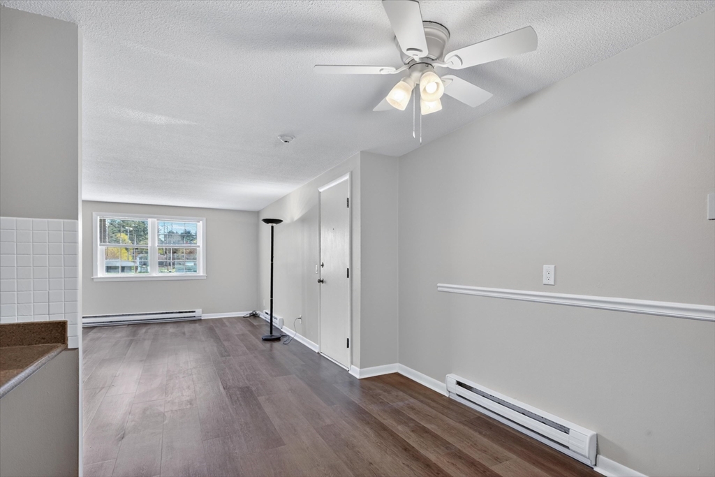 91 Pleasant Street, Unit A6 Medfield, MA 02052 - Photo 5 of 17 wooden floor in an empty room with a window