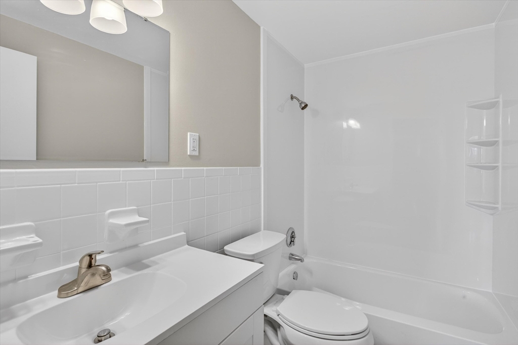 91 Pleasant Street, Unit A6 Medfield, MA 02052 - Photo 8 of 17 a bathroom with a sink toilet and shower