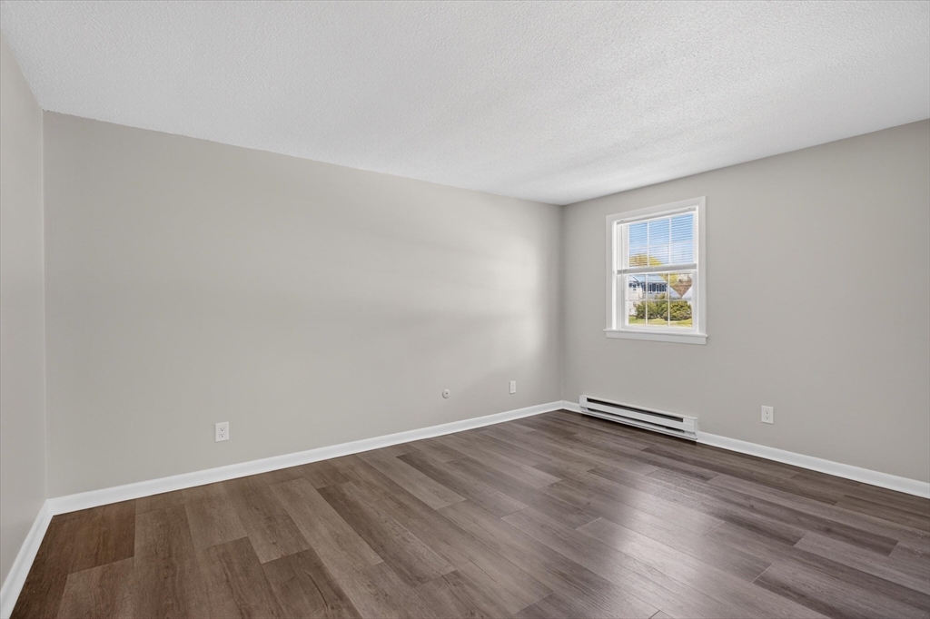 91 Pleasant Street, Unit A6 Medfield, MA 02052 - Photo 10 of 17 an empty room with a workspace