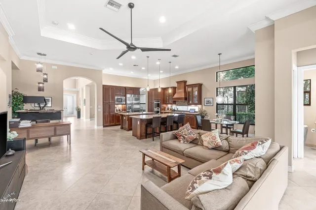 a living room with lots of furniture and kitchen view