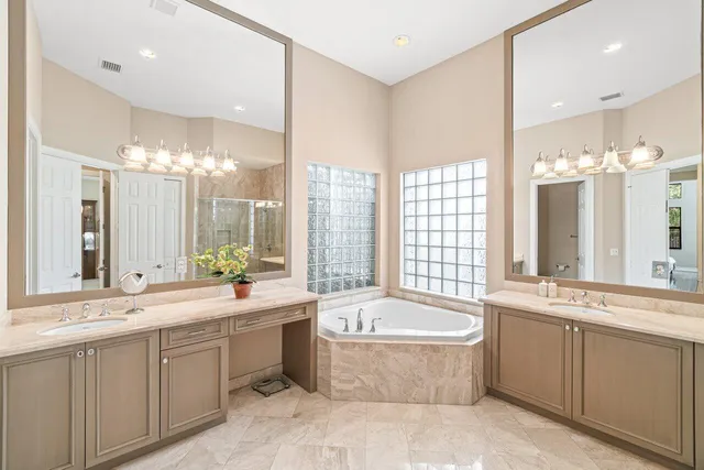 a large bathroom with a large tub and sink