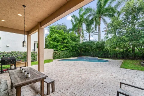 a view of house with swimming pool and yard