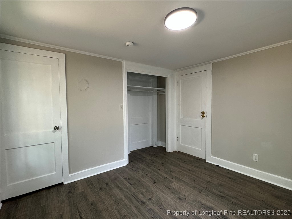293 Army Road Raeford, NC 28376 - Photo 14 of 31 an empty room with wooden floor and windows