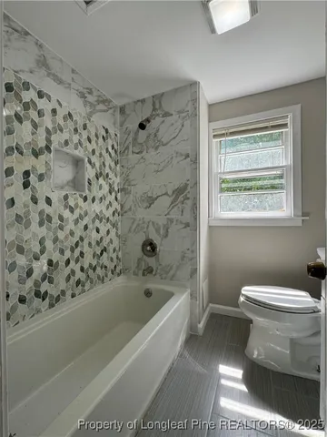 a bathroom with a toilet and a bathtub