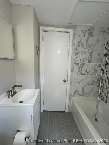 a bathroom with a bathtub and a sink