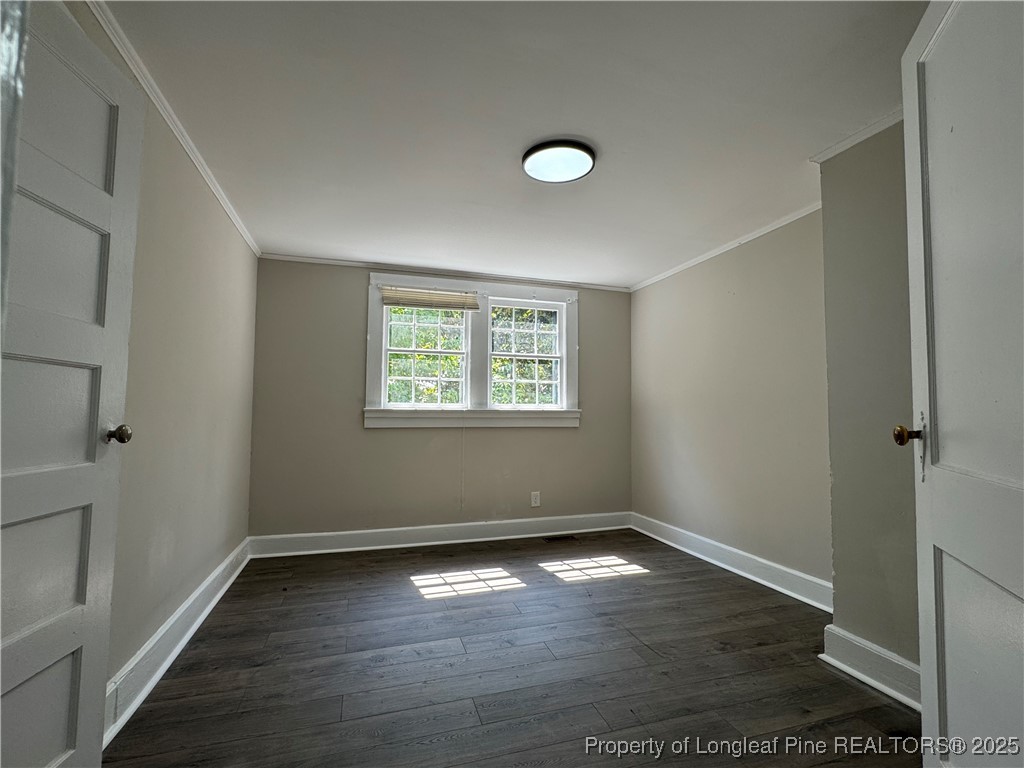 293 Army Road Raeford, NC 28376 - Photo 17 of 31 an empty room with wooden floor and windows