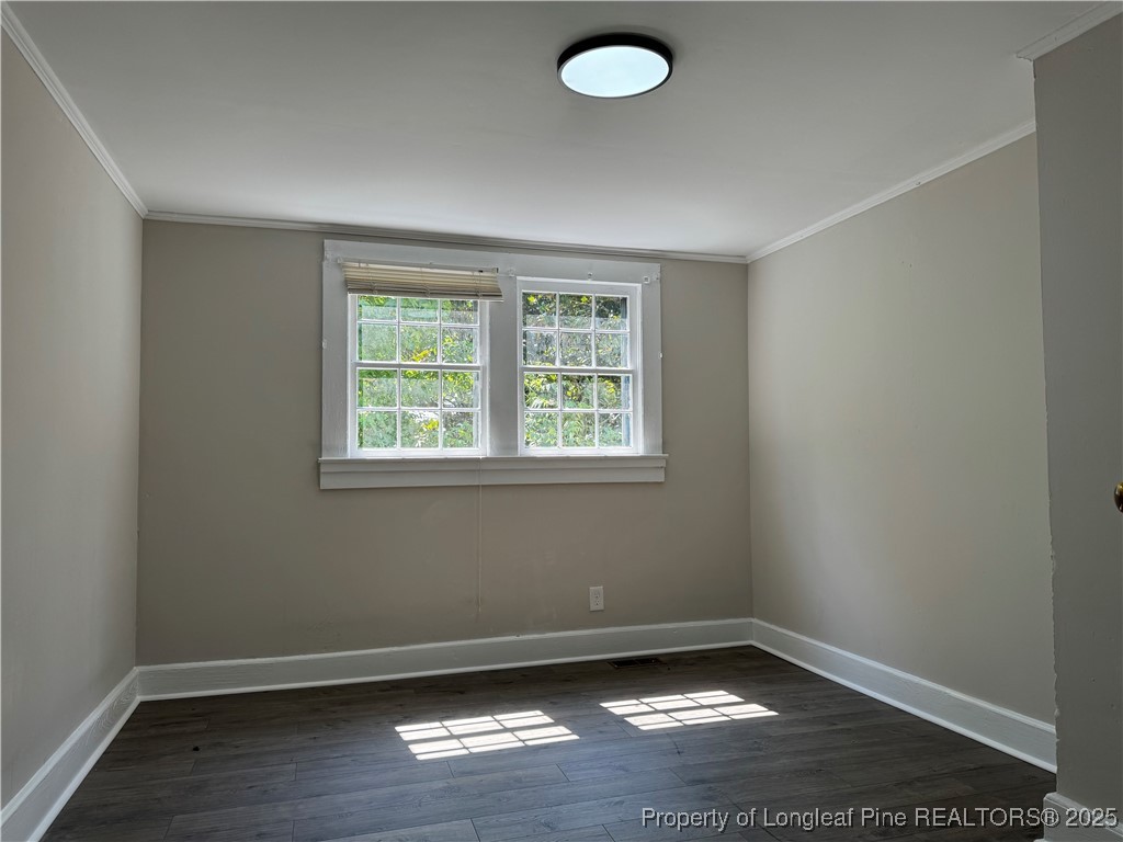 293 Army Road Raeford, NC 28376 - Photo 18 of 31 an empty room with wooden floor and windows