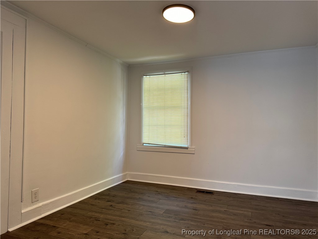 293 Army Road Raeford, NC 28376 - Photo 19 of 31 an empty room with wooden floor and windows