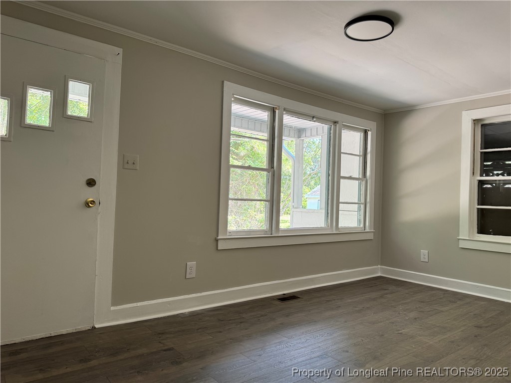 293 Army Road Raeford, NC 28376 - Photo 22 of 31 an empty room with wooden floor and windows