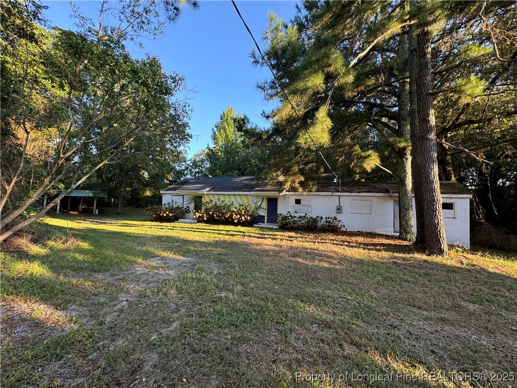 293 Army Road Raeford, NC 28376 - Photo 23 of 31 a front view of a house with a yard and trees