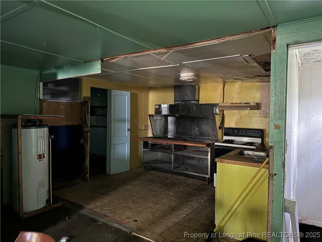 a kitchen with stainless steel appliances granite countertop a refrigerator and a stove