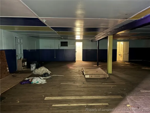 a room with lots of furniture and a wooden floor