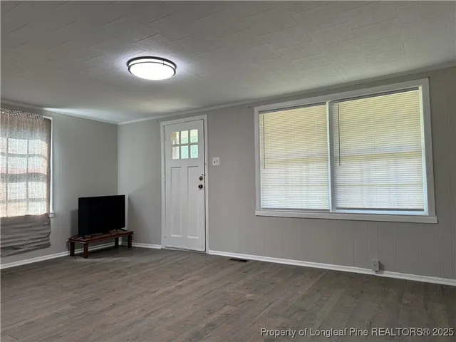 an living room with window and a flat screen tv