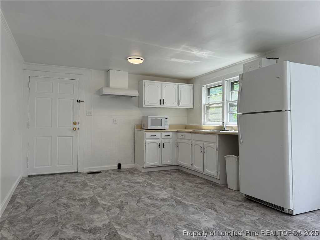 293 Army Road Raeford, NC 28376 - Photo 9 of 31 a kitchen with white cabinets and white appliances