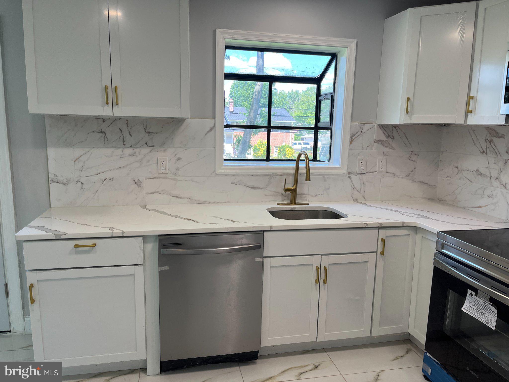 2405 Limestone Road Wilmington, DE 19808 - Photo 13 of 40 a kitchen with white cabinets appliances and a sink