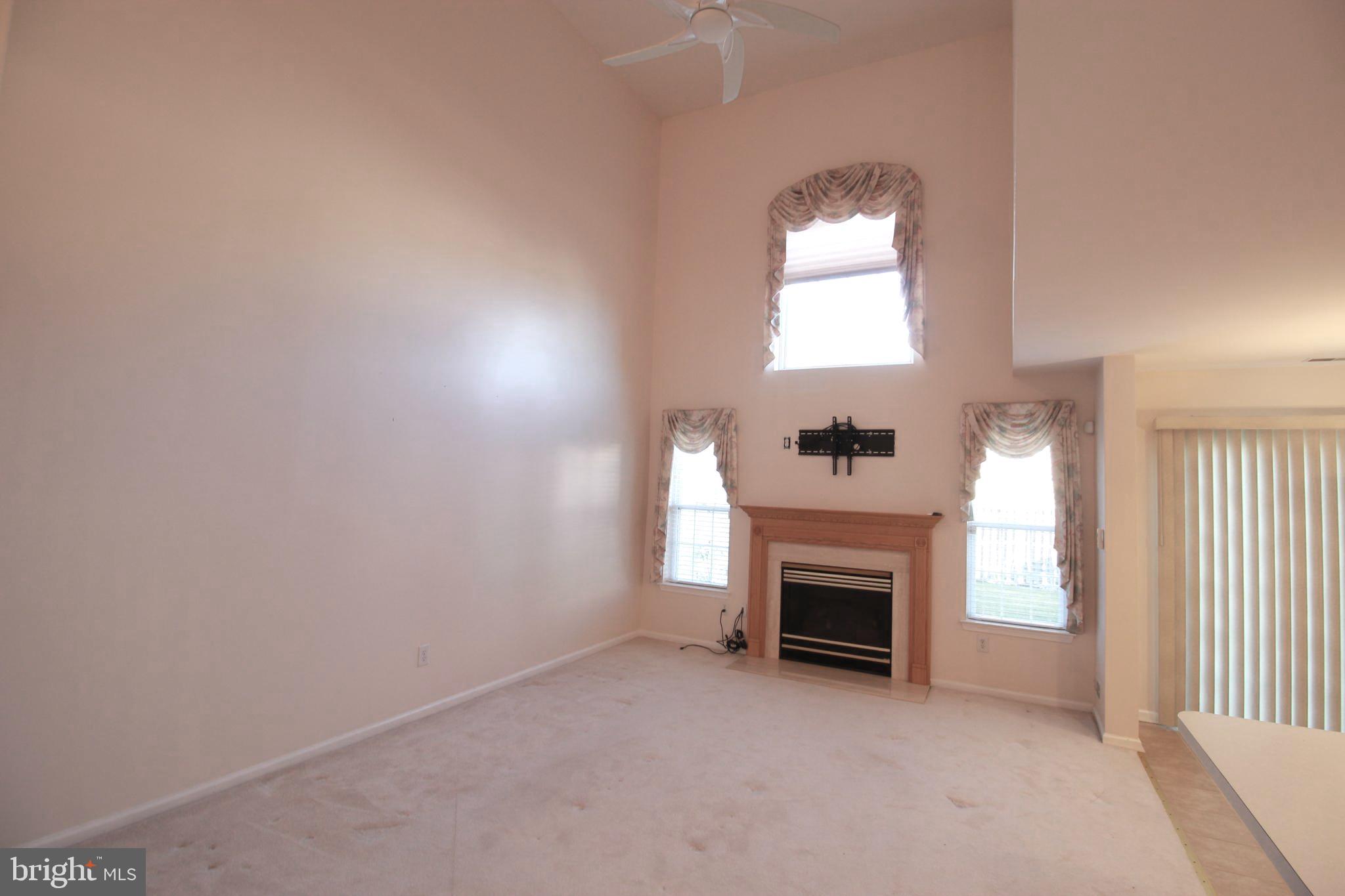 30 Leighton Drive Mount Laurel, NJ 08054 - Photo 10 of 22 an empty room with a fireplace and window