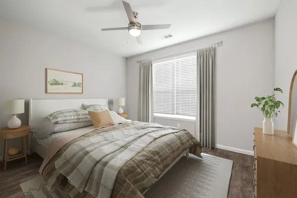a bedroom with a bed and a potted plant