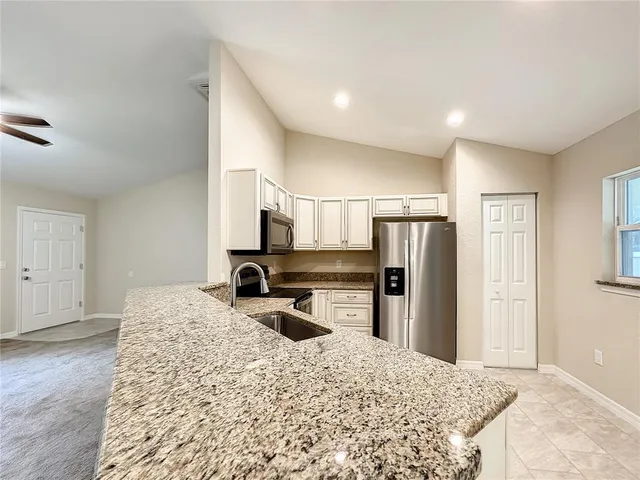 a kitchen with refrigerator and window