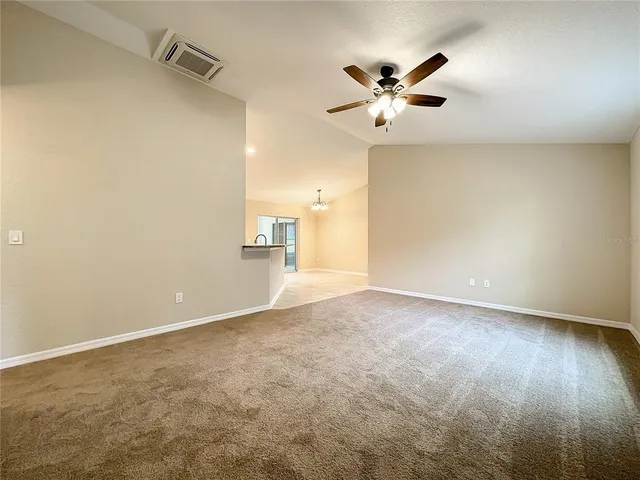 a view of a livingroom with a ceiling fan and wooden floor