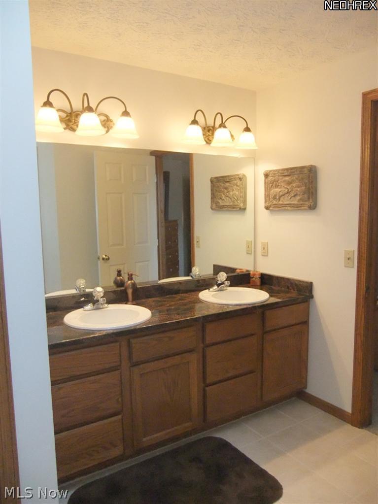 3795 Stonebridge Boulevard Akron, OH 44321 - Photo 17 of 24 The master bedroom suite also features a full glamour bathroom that features double sinks with granite countertops...