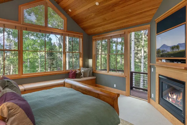 a spacious bedroom with a large bed and a fireplace