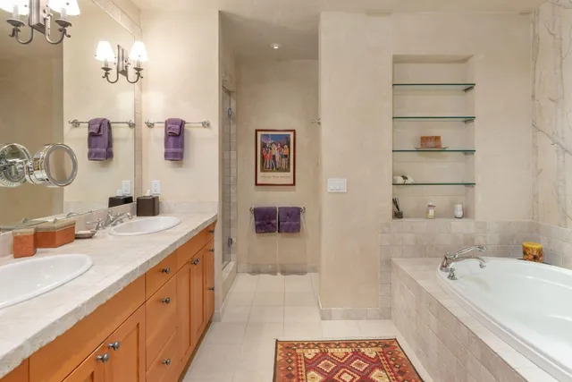 a bathroom with a tub sink and mirror