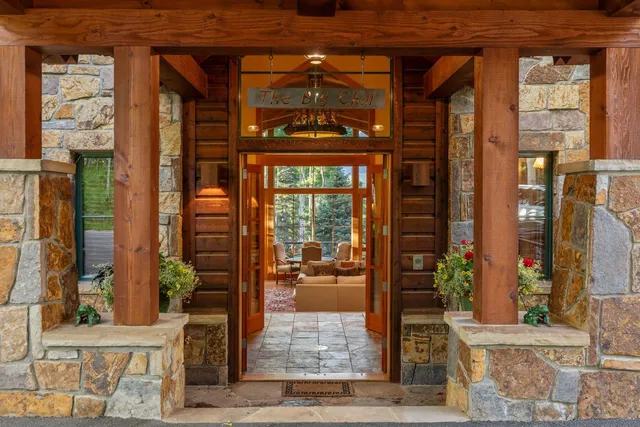a balcony with wooden floor table and chairs