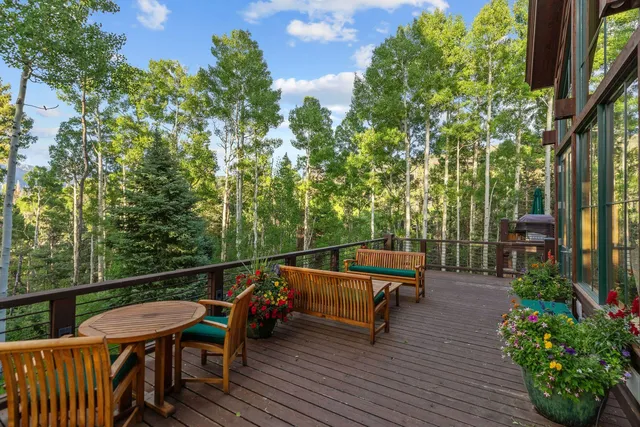 a front view of a house with a garden and tree