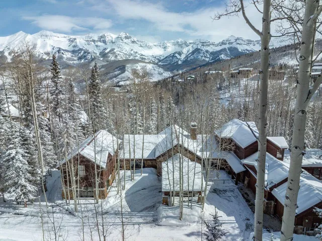 a front view of a house with a yard covered with snow in the outdoor